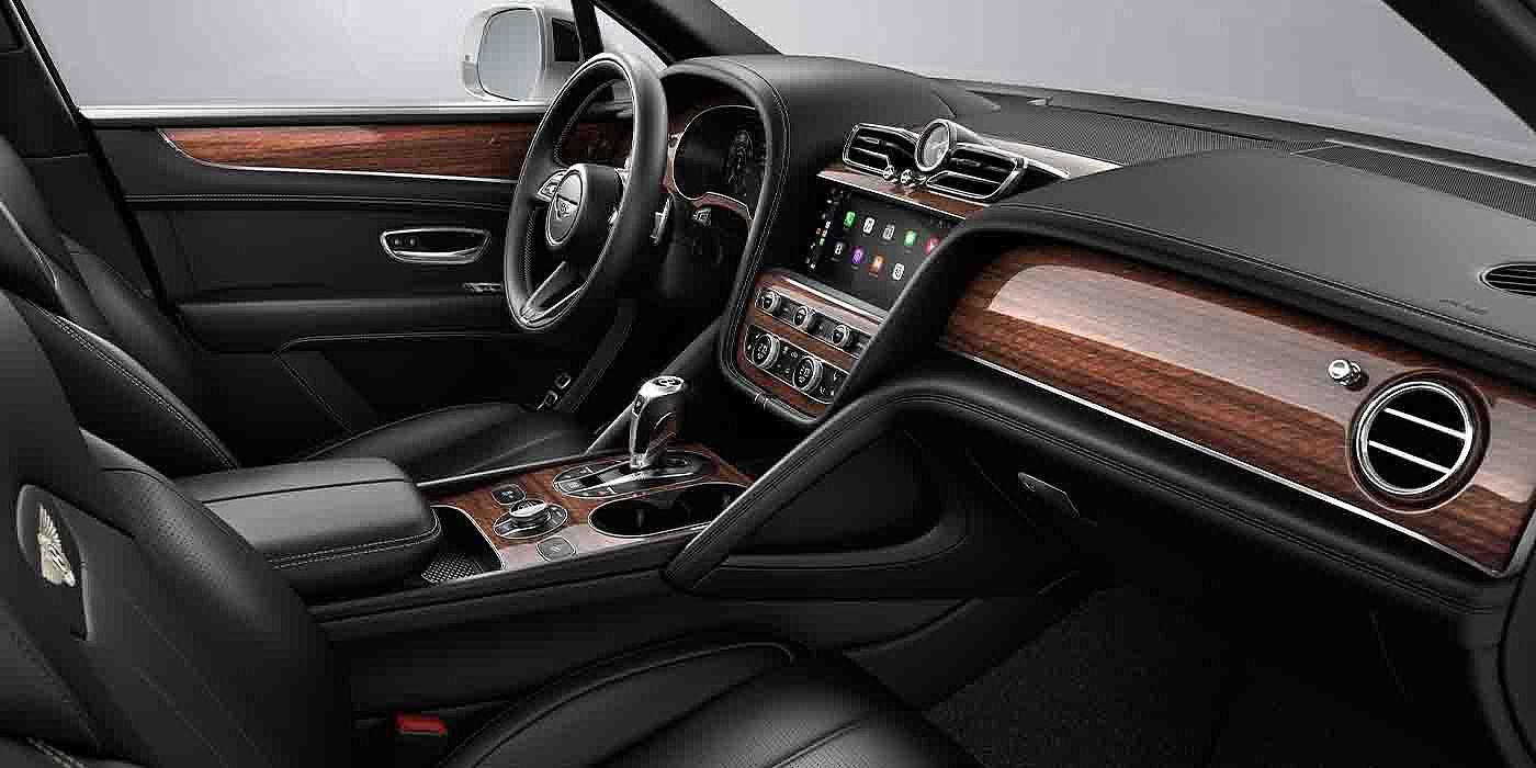 Bentley Milano Bentley Bentayga EWB interior with a Crown Cut Walnut veneer, view from the passenger seat over looking the driver's seat.